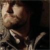 muccamukk: Athos looking up with an ironic half smile. (Musketeers: Wry Look)