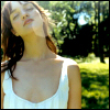 lattara: woman standing with her face at an angle to the sun, with the sunlight reflectin off of the camera's lens (Default)