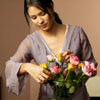 genarti: Woman arranging roses in a vase. ([misc] find a moment's beauty)