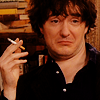 thingswithwings: Bernard Black with a silly face and a cigarette in his hand (Black Books - Bernard looking silly and)