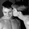 fleurrochard: A black and white picture of two guys, one kissing the other on the cheek, the other smiling (love)