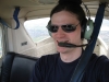 crazyscot: Self-portrait of me in a light aircraft aloft (flying)