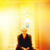 amihan: christopher eccleston as the ninth doctor, seated and smiling, against an orange-yellow background ([doctor who] nine (yellow))