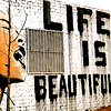 meloukhia: Graffiti reads 'life is beautiful,' opposite a person with mouth wide open, as though shouting (Life is beautiful)