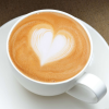 kass: a latte in a teacup with a heart shape drawn in the foam (latte)