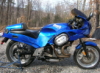 hecu_marine: A blue Buell RS1200 motorcycle seen from the right side in front of leafless trees. (motorcycle)