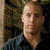 thirteen_pillars: An olive-skinned bald man (Vin Diesel) looks slightly left of camera. He looks dubious. (Dubious)