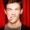 next_to_normal: Grant Gustin, red background, making a silly face (Grant silly face)