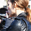recessional: a woman in a leather jacket lights a cigarette (personal; i enjoy being a girl)
