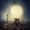 futuransky: a small silhouetted person beside a large shiny lightbulb (idea!)