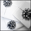 amadi: A photo of a pile of gift wrapped boxes with silver bows (Gifts)