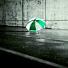 skieswideopen: A green-and-white umbrella sits on the ground (Umbrella)