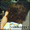 yarngeek: yarngeek on the floor, hair done Cousin IT style. German picture book is flat on the floor. Text says "[yarngeek]." (tired)