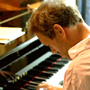 athousandsmiles: House with his head bent low as he plays his piano. (House at his piano)