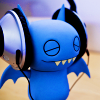 snowcipher: bat figurine wearing headphones (batmusic)