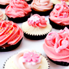 panda: photo of pink cupcakes with decorative frosting (food: om nom nom nom)