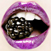 vihrava: A blackberry between violet lips. (Blackberry)