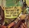 fridgepunk: A sign on garrus' back reading "Shoot a rocket into my ugly stupid face" (Default)