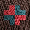 pinesandmaples: A blue and red cross on a brown background, all made of yarn. Based on a mitered square. (knitting: square)