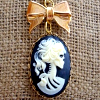 rhi: A cameo of a Victorian skeleton in profile, with hairbow. (Halloween)
