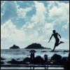 surexit: A silhouetted figure leaping into the sea. (leap of faith)