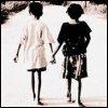 surexit: Two young girls walking away from the camera holding hands. (let's stick together)