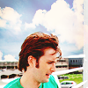 dreamtofbeing: David Tennant in front of an outdoors commercial/airport background. Looking down. (green shirt)