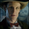 jjhunter: Eleventh Doctor with Stensen; clock hovers over one shoulder, skulls over the other; lighting is dim and cool (timelord)