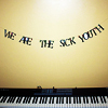 theresistance: A banner reading "WE ARE THE SICK YOUTH" hanging over an electric keyboard (Default)