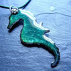 theresistance: A teal seahorse-shaped necklace pendant (Little Seahorse)