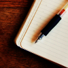 add_a_writer: Open book with pen laying on it (pen)