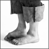 rydra_wong: Two bare feet and ankles sticking out of rolled-up jeans. (body -- barefoot)