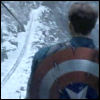 rhi: Captain America, shield over his back, staring down at a valley & railroad tracks (Captain America)