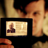 fera_festiva: The eleventh doctor holding up an ID card showing the face of the first doctor (dw: ID card)