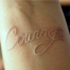 alwayswondered: A white tattoo reading 'courage' on the inside of a wrist. (I'm unafraid; I'm gonna show my scar)