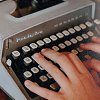 elaineofshalott: Photo of fingers on the keys of a gray, 1970s?-era typewriter. (typing)