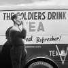 kindkit: 'A man in WWII-era military uniform drinks tea in front of a van painted with "The Soldiers' Drink: Tea" (Fandomless: Soldiers drink tea)